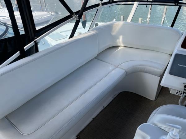 Slide: The Image of 2001 Silverton 330 Sport Bridge interior seating area with white upholstery. - 11