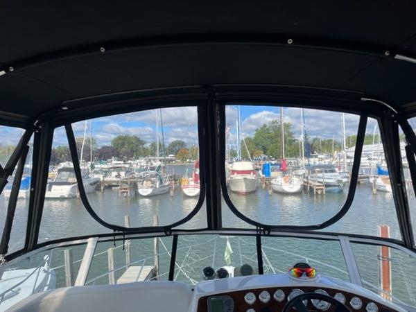 Slide: The Image of View from the helm of a 2001 Silverton 330 Sport Bridge in a marina. - 12