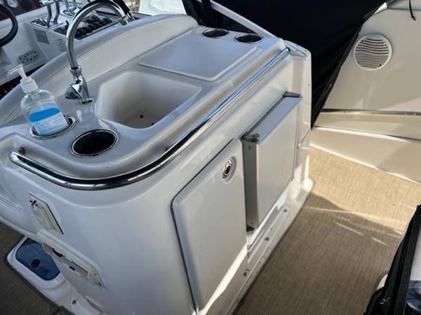 Slide: The Image of 2001 Silverton 330 Sport Bridge boat interior with sink and storage. - 14
