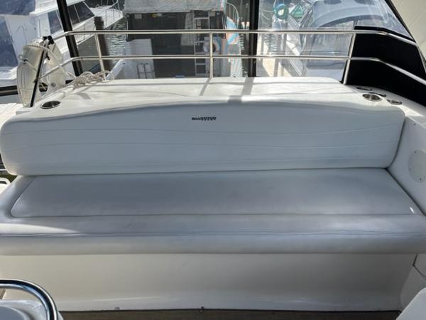 Slide: The Image of 2001 Silverton 330 Sport Bridge white cushioned seating area on deck. - 15