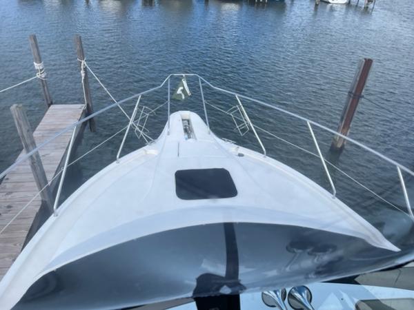 Slide: The Image of 2001 Silverton 330 Sport Bridge docked at a marina. - 16