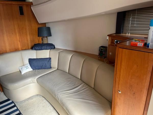 Slide: The Image of Interior of 2001 Silverton 330 Sport Bridge with beige leather sofa and wooden cabinetry. - 20