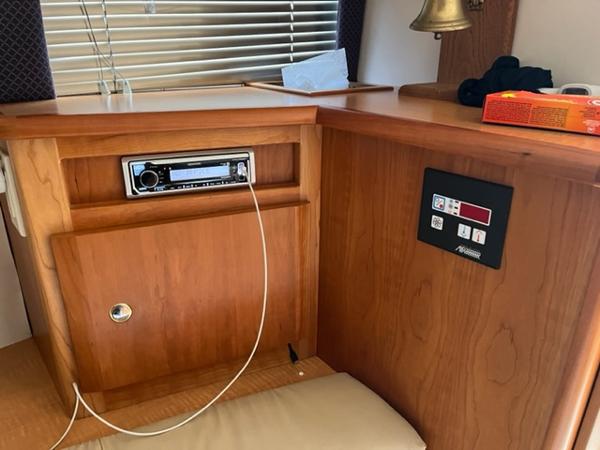 Slide: The Image of Interior of a 2001 Silverton 330 Sport Bridge with wooden cabinetry and control panel. - 21