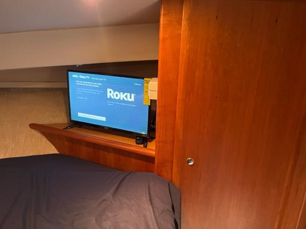Slide: The Image of 2001 Silverton 330 Sport Bridge interior with Roku TV setup in bedroom. - 25