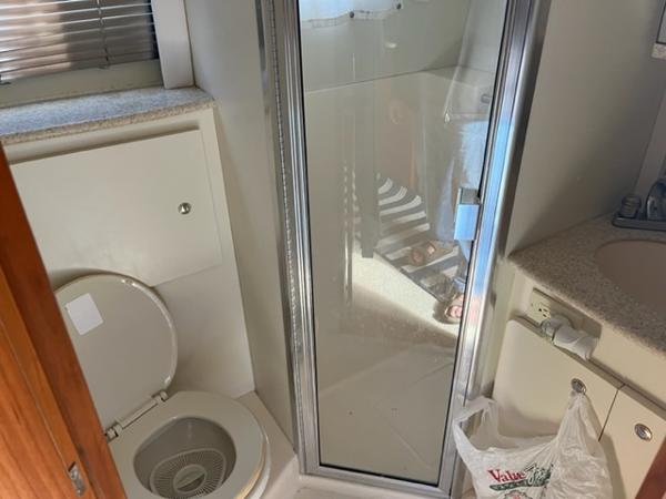 Slide: The Image of 2001 Silverton 330 Sport Bridge bathroom with toilet, shower, and sink. - 26