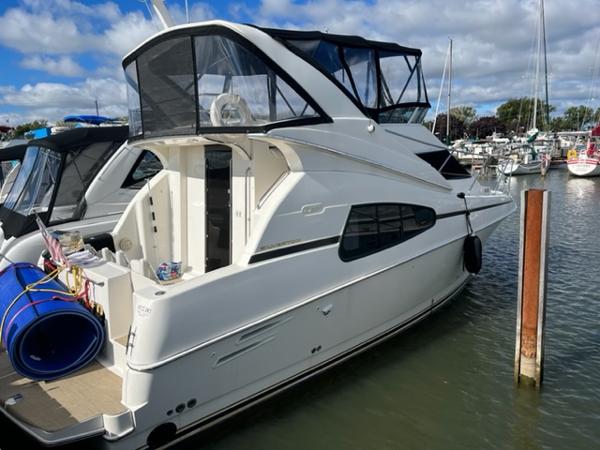 Slide: The Image of 2001 Silverton 330 Sport Bridge yacht docked at marina. - 4