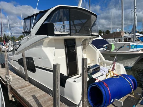 Slide: The Image of 2001 Silverton 330 Sport Bridge yacht docked at marina. - 5