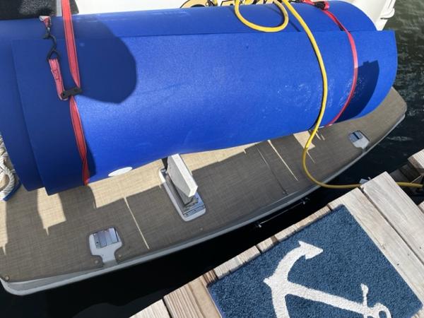 Slide: The Image of 2001 Silverton 330 Sport Bridge swim platform with blue marine mat and rolled-up float. - 6