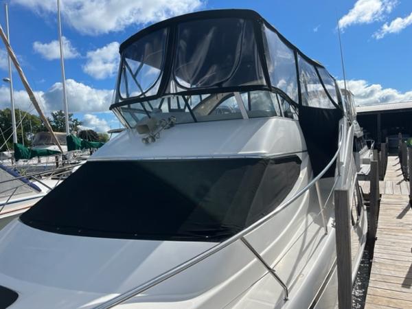 Slide: The Image of 2001 Silverton 330 Sport Bridge yacht docked at marina under blue sky. - 7