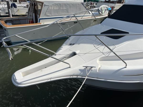Slide: The Image of 2001 Silverton 330 Sport Bridge yacht docked at marina. - 8