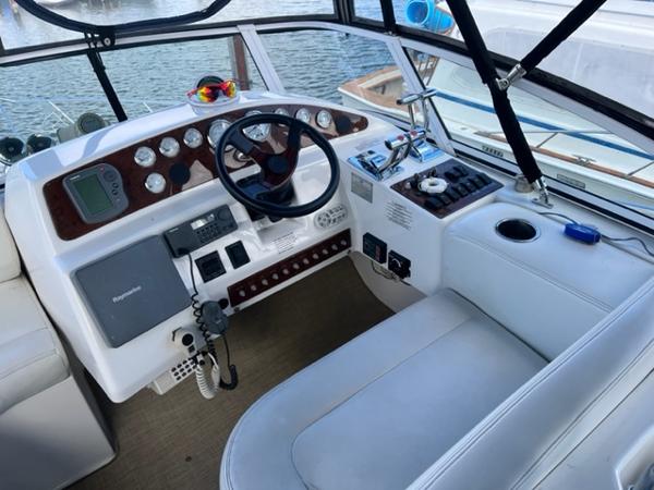 Slide: The Image of 2001 Silverton 330 Sport Bridge helm with steering wheel, controls, and navigation equipment. - 9