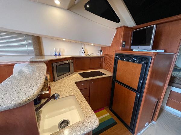 Slide: The Image of Interior of 2007 Silverton 330 Sport Bridge yacht with modern kitchen amenities. - 14