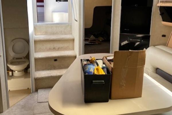 Slide: The Image of Interior of a 1990 Silverton 34 Express boat with stairs, toilet, and table. - 19