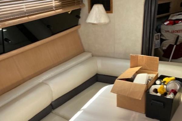 Slide: The Image of Interior of a 1990 Silverton 34 Express boat with white seating and storage boxes. - 22