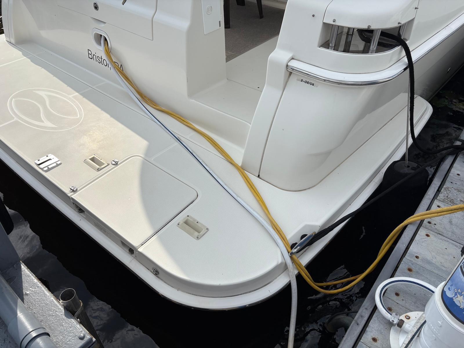 Slide: The Image of 2006 Silverton 38 Sport Bridge yacht docked with power cables connected. - 13