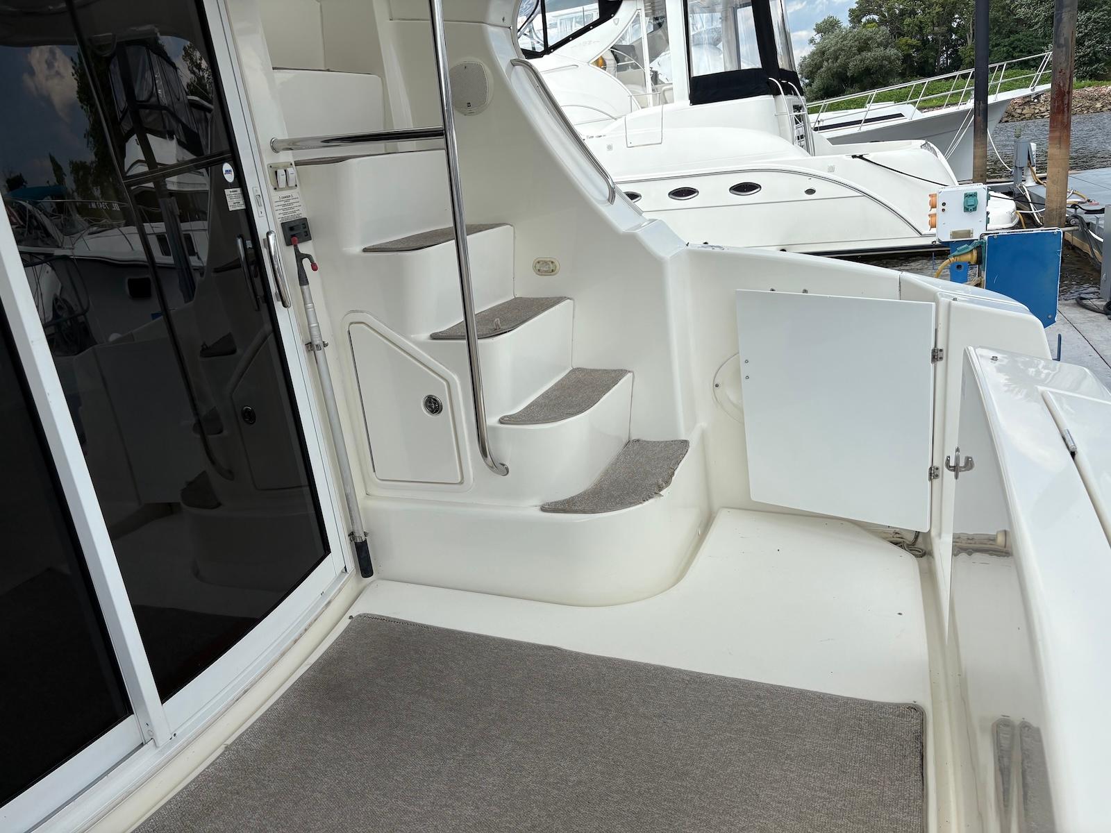 Slide: The Image of 2006 Silverton 38 Sport Bridge yacht interior with carpeted stairs and sleek design. - 15