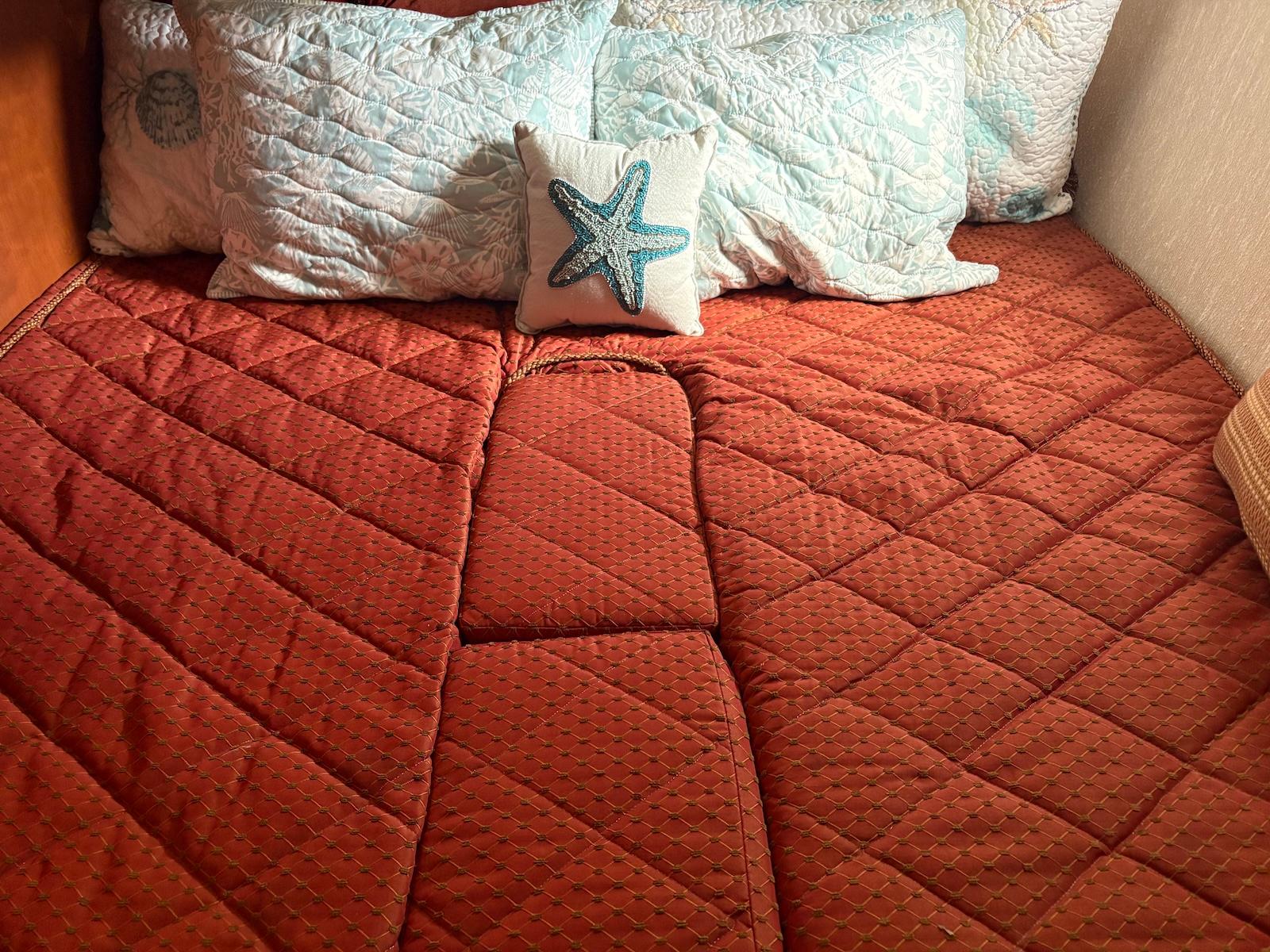 Slide: The Image of Cozy bed with red quilt and starfish pillow on 2006 Silverton 38 Sport Bridge. - 27
