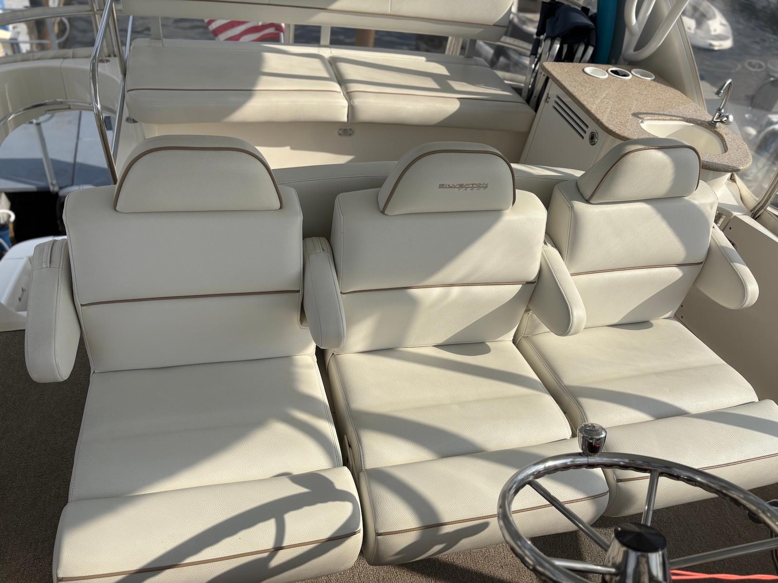 Slide: The Image of 2006 Silverton 38 Sport Bridge interior with white leather seating and steering wheel. - 3