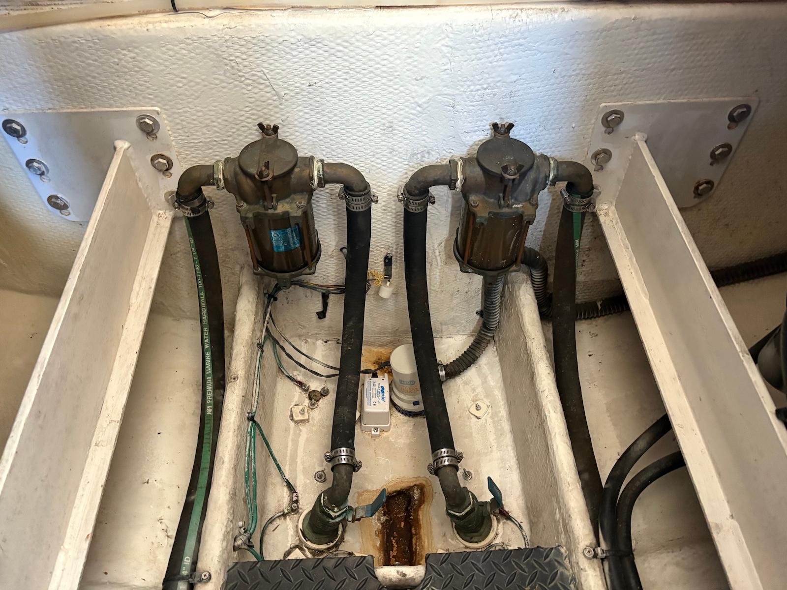Slide: The Image of Engine compartment of a 2006 Silverton 38 Sport Bridge with visible hoses and filters. - 34