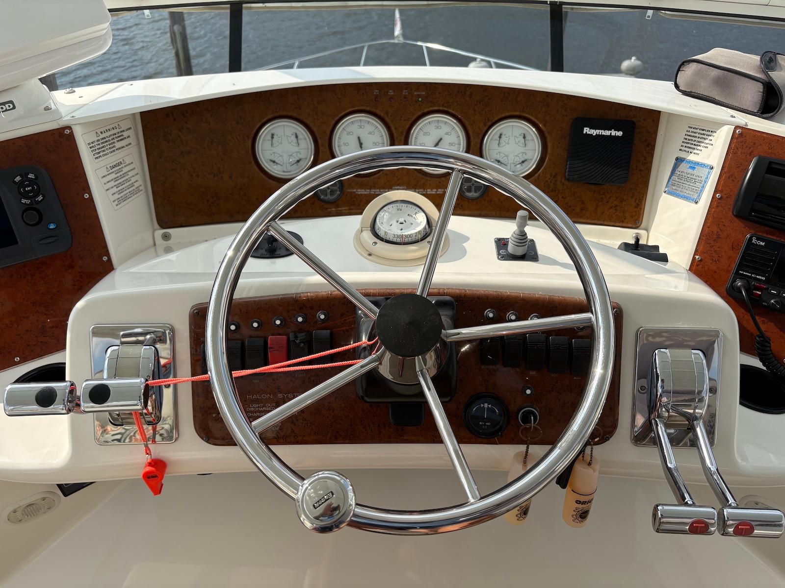Slide: The Image of Helm of 2006 Silverton 38 Sport Bridge with steering wheel and control panel. - 7