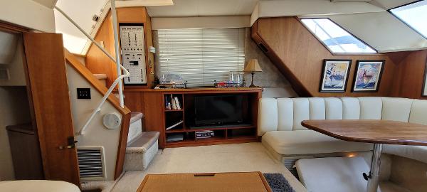 Slide: The Image of Interior of a 2000 Silverton 392 Motor Yacht with seating, TV, and dining area. - 18