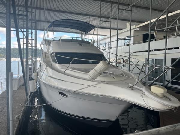 Slide: The Image of 2002 Silverton 39 Motor Yacht docked in a covered marina. - 1