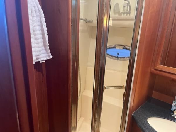 Slide: The Image of 2002 Silverton 39 Motor Yacht bathroom with shower and sink. - 11