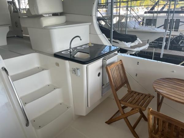 Slide: The Image of 2002 Silverton 39 Motor Yacht interior with kitchenette and seating area. - 27