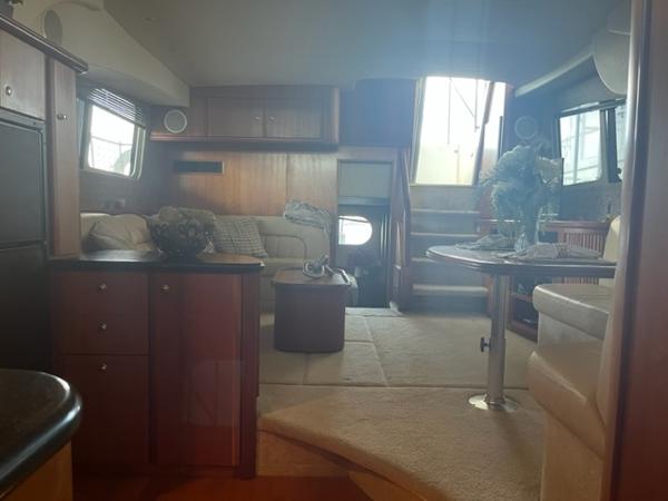 Slide: The Image of Interior of a 2002 Silverton 39 Motor Yacht with cozy seating and elegant decor. - 6