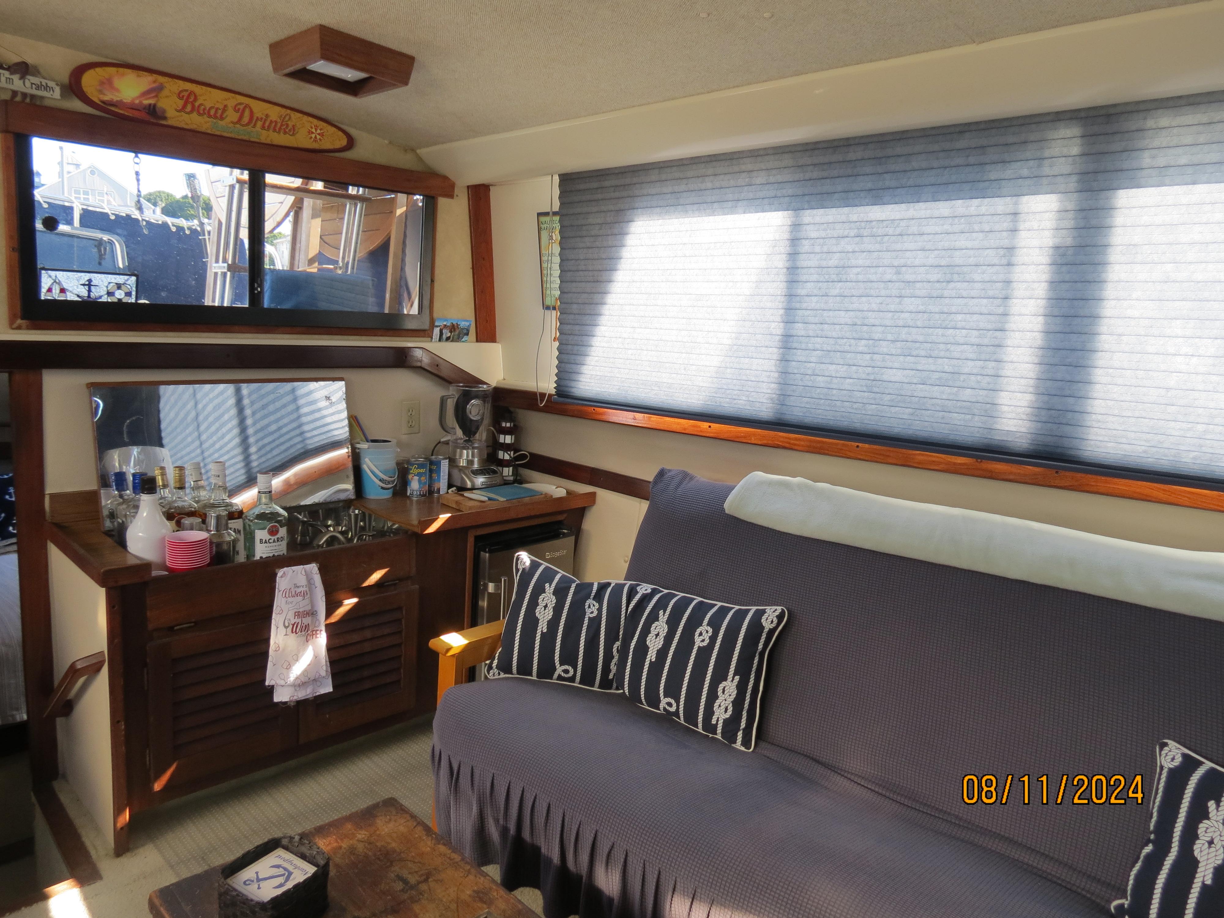 Slide: The Image of Interior of 1983 Silverton 40 Aft Cabin with bar area and cozy seating. - 16