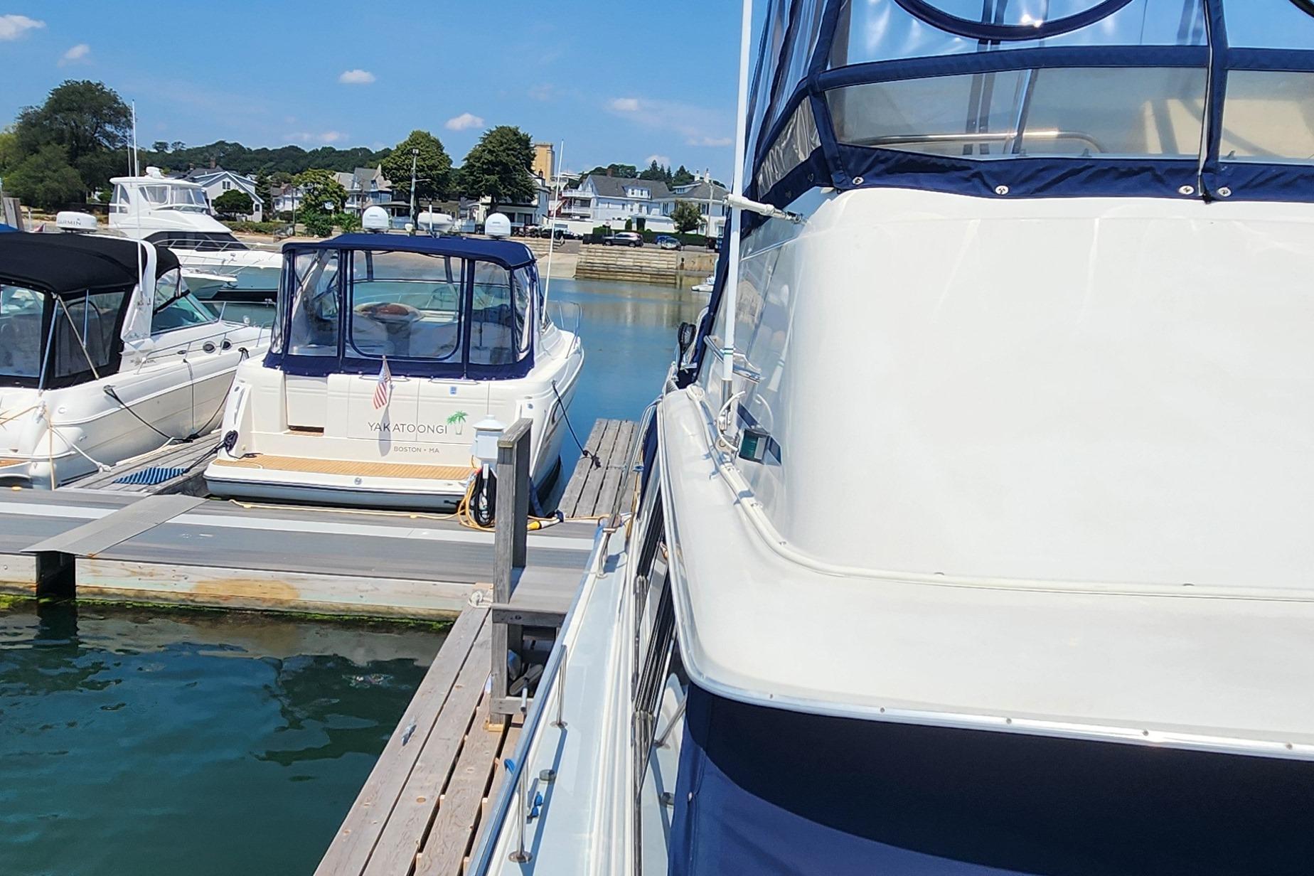 Slide: The Image of 1983 Silverton 40 Aft Cabin docked at a marina on a sunny day. - 7