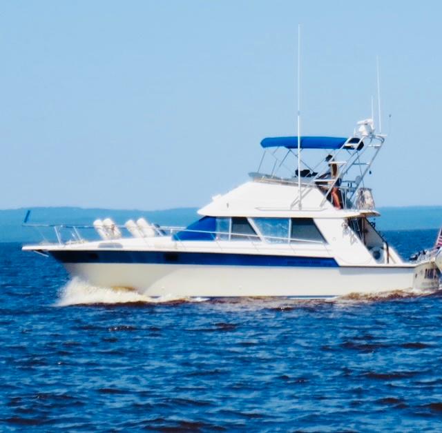 Slide: The Image of 1988 Silverton 40 Convertible yacht cruising on open water. - 1