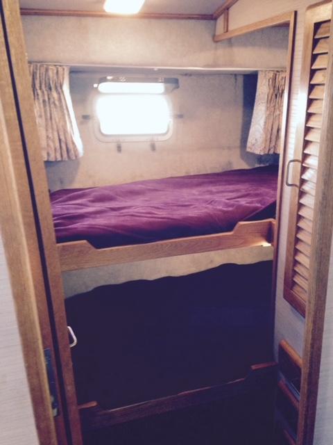 Slide: The Image of 1988 Silverton 40 Convertible cabin with bunk beds and window. - 12