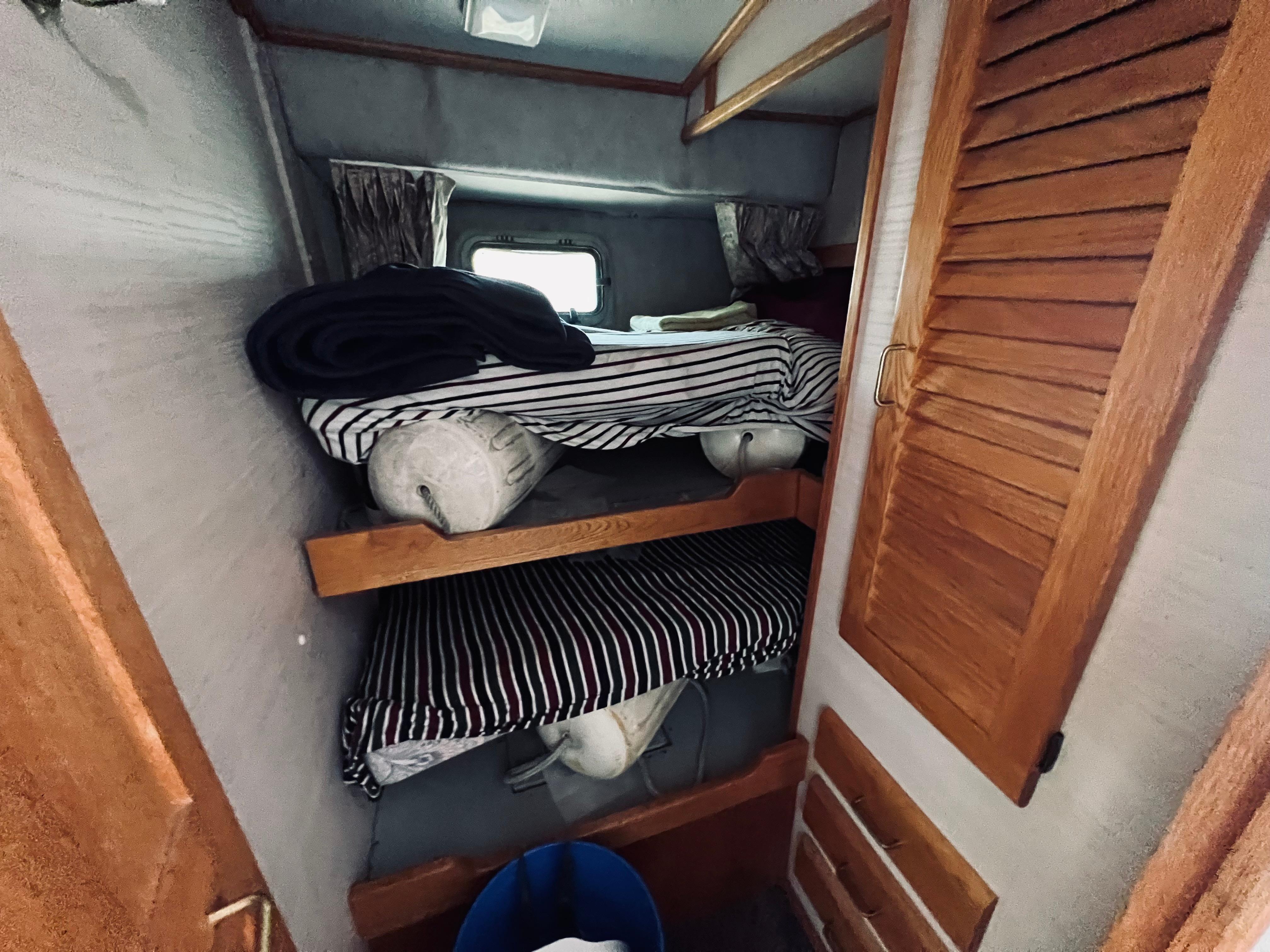 Slide: The Image of Interior of 1988 Silverton 40 Convertible with bunk beds and wooden cabinetry. - 13