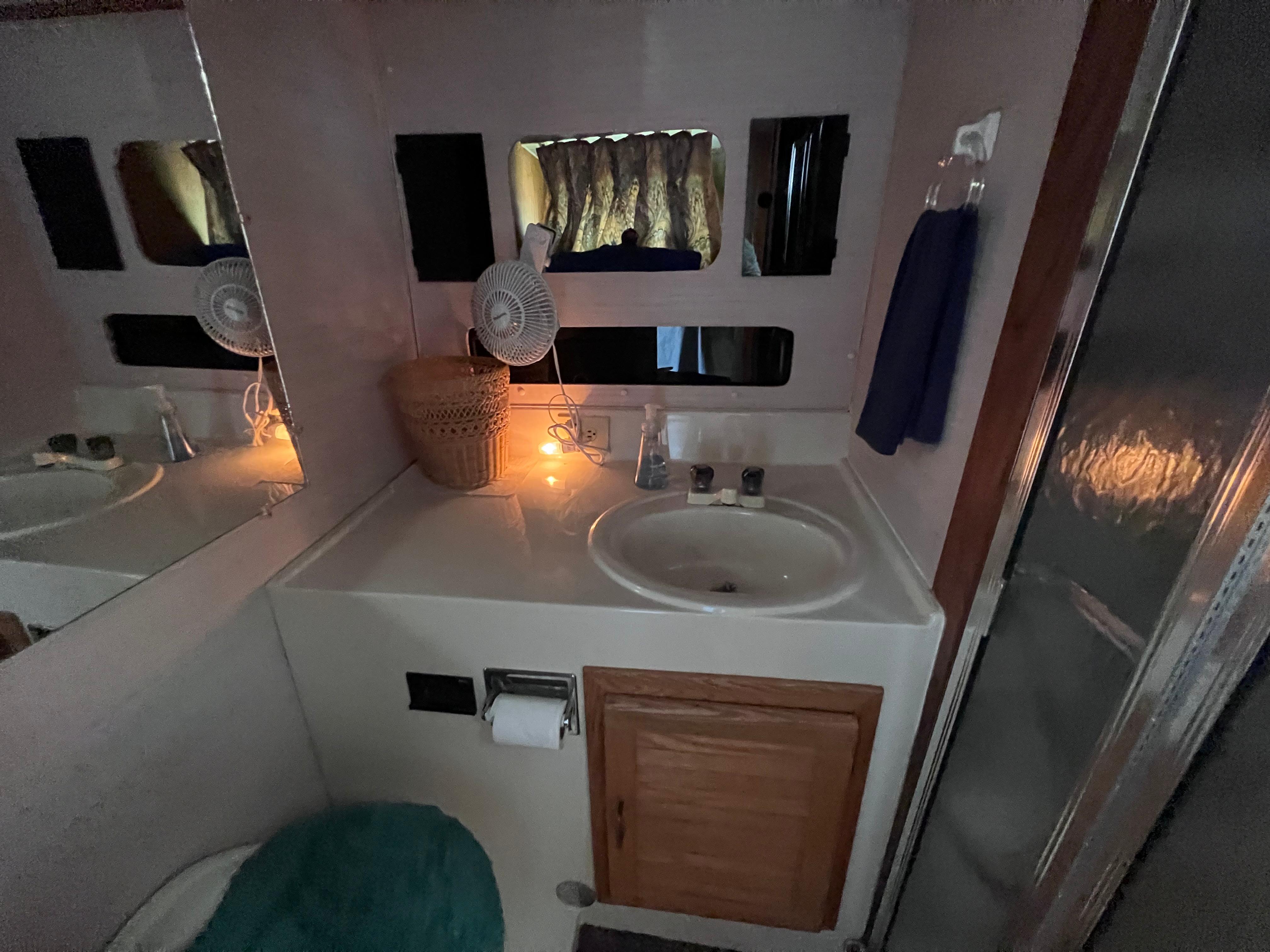 Slide: The Image of Bathroom interior of a 1988 Silverton 40 Convertible yacht, featuring a sink and mirror. - 15