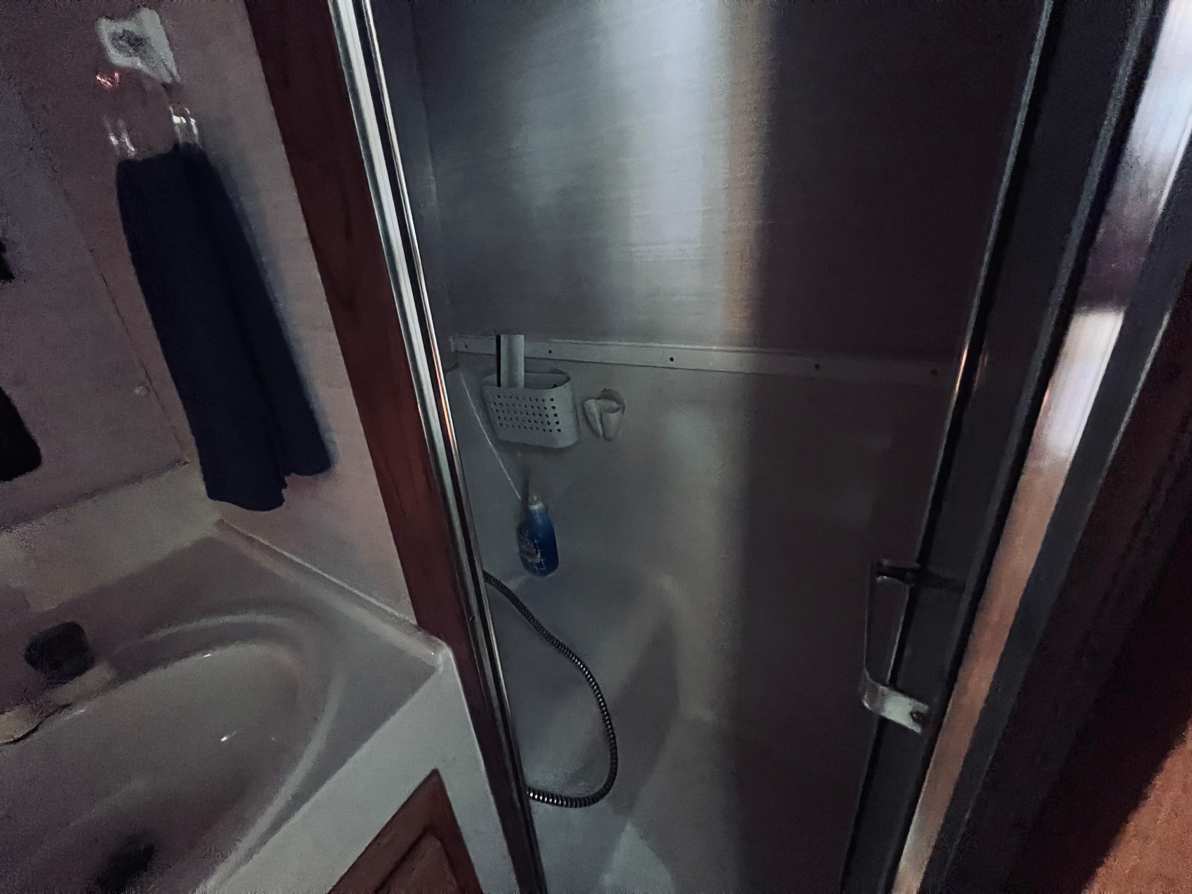 Slide: The Image of Bathroom interior of 1988 Silverton 40 Convertible yacht, featuring shower and sink. - 16