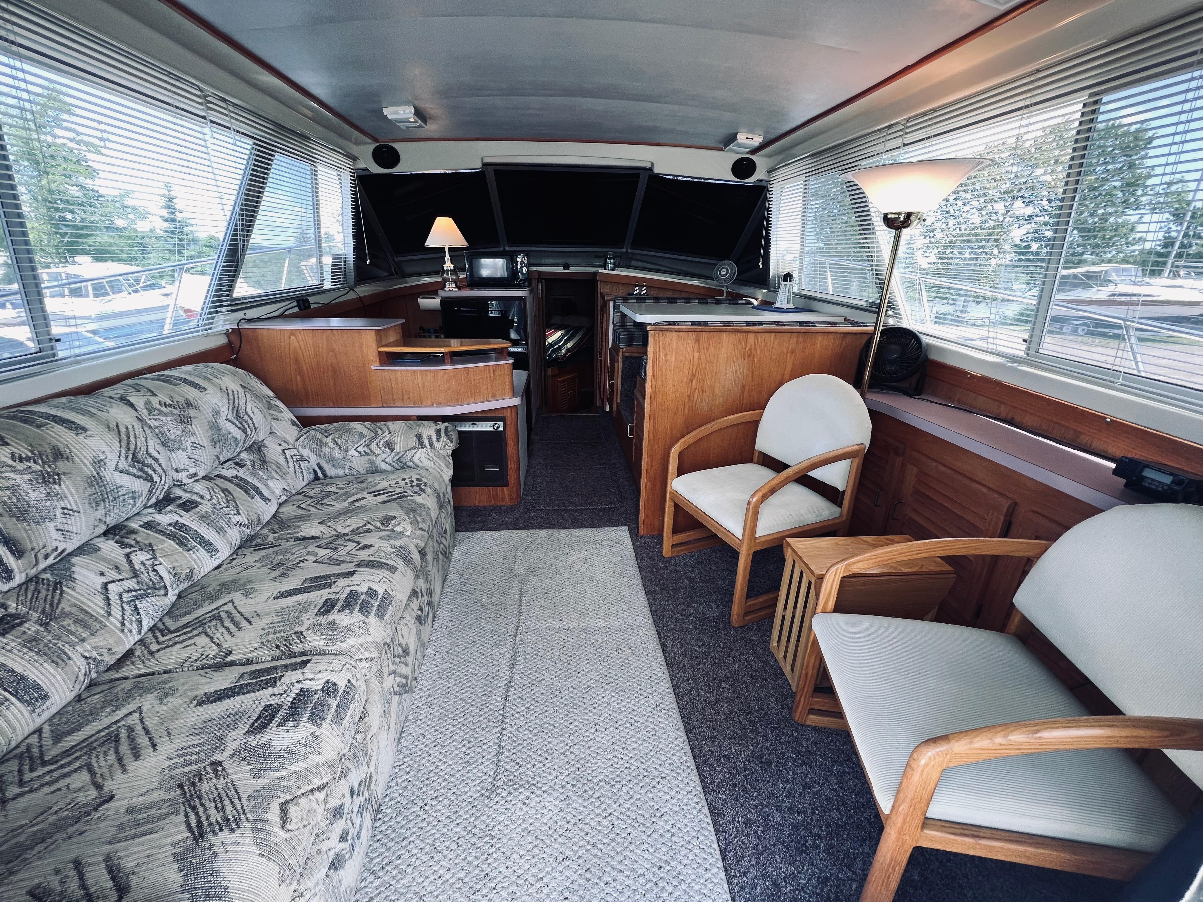 Slide: The Image of Interior of a 1988 Silverton 40 Convertible yacht with cozy seating and elegant decor. - 6