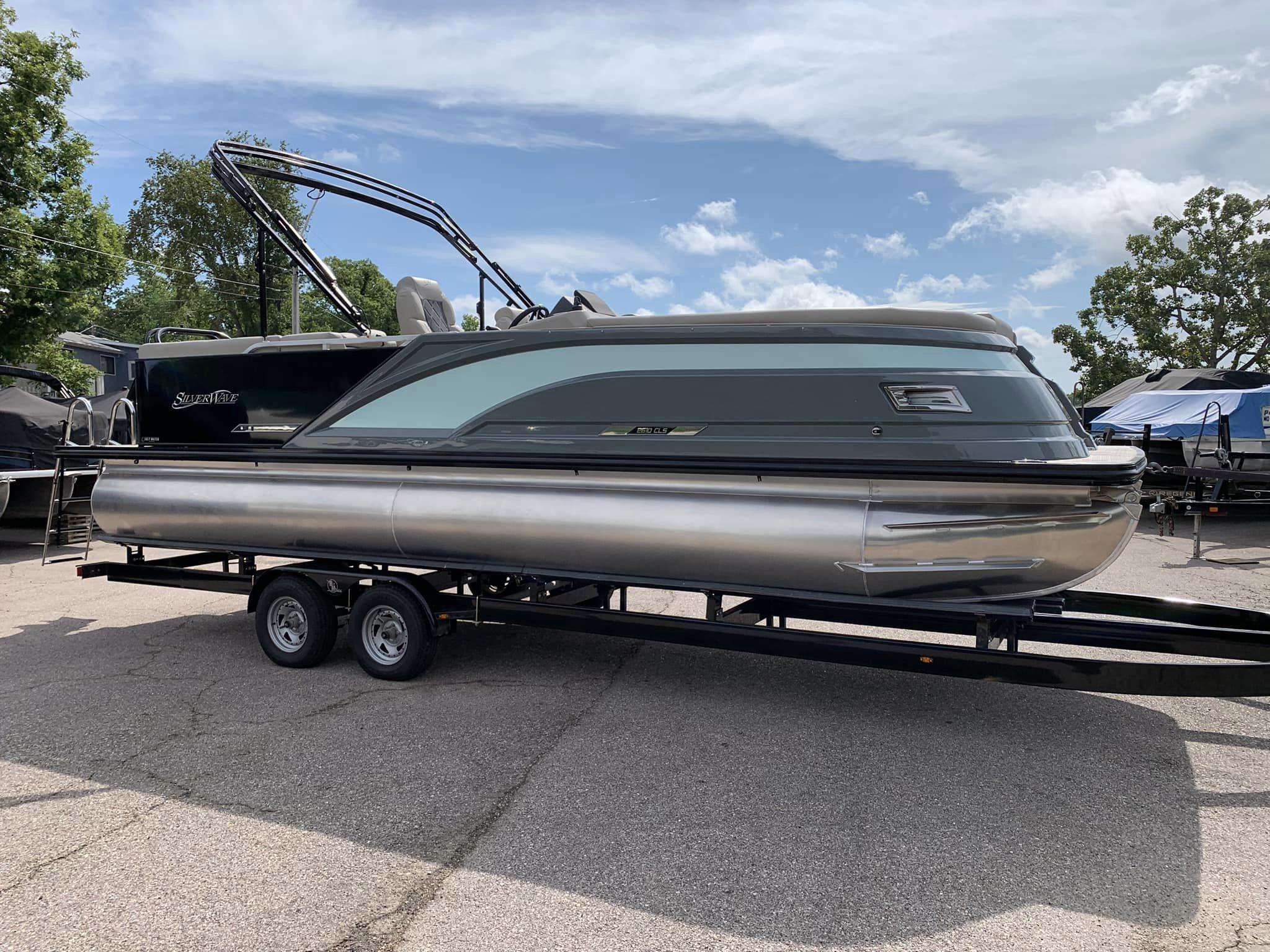 Slide: The Image of 2024 Silver Wave 2610 SW5 CLS pontoon boat on trailer, parked outdoors. - 1