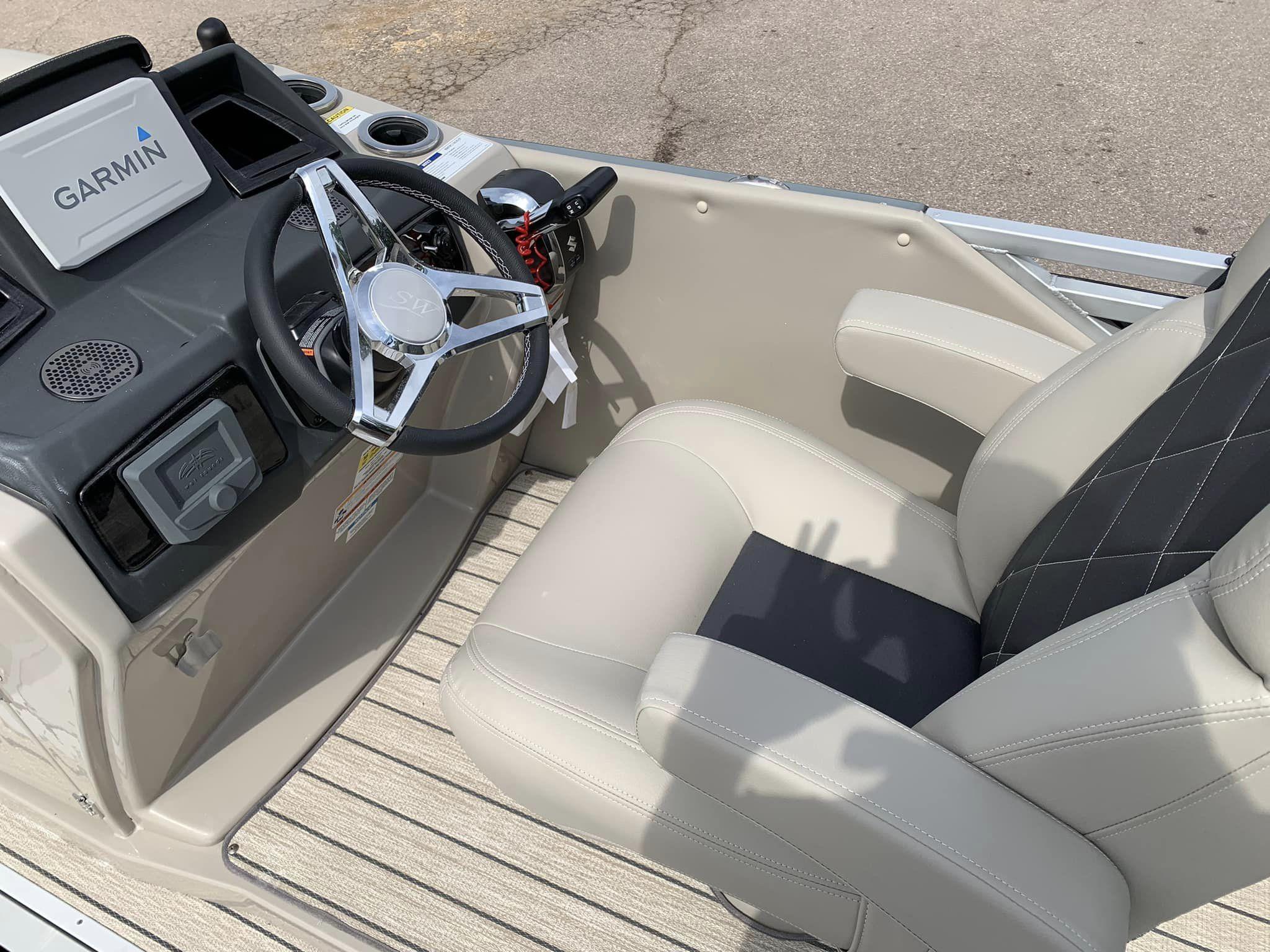 Slide: The Image of 2024 Silver Wave 2610 SW5 CLS boat cockpit with Garmin navigation system and plush seating. - 10
