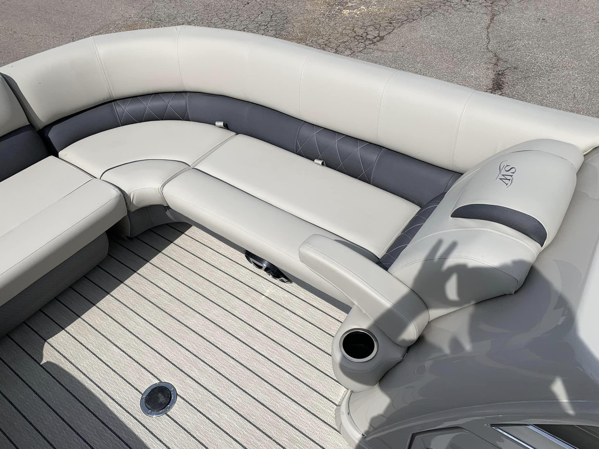 Slide: The Image of 2024 Silver Wave 2610 SW5 CLS boat interior with plush seating and cup holder. - 11