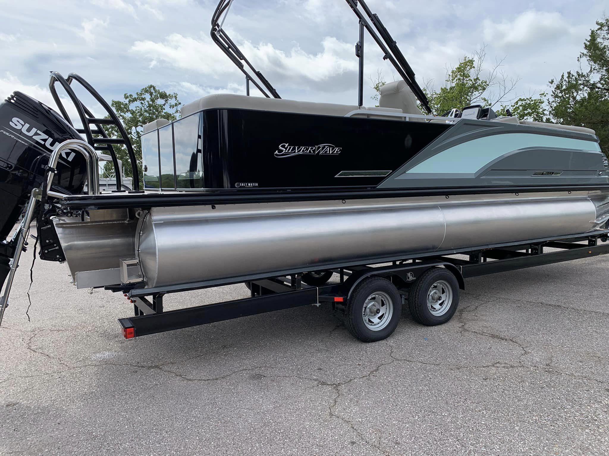 Slide: The Image of 2024 Silver Wave 2610 SW5 CLS pontoon boat on trailer, featuring Suzuki outboard motor. - 13