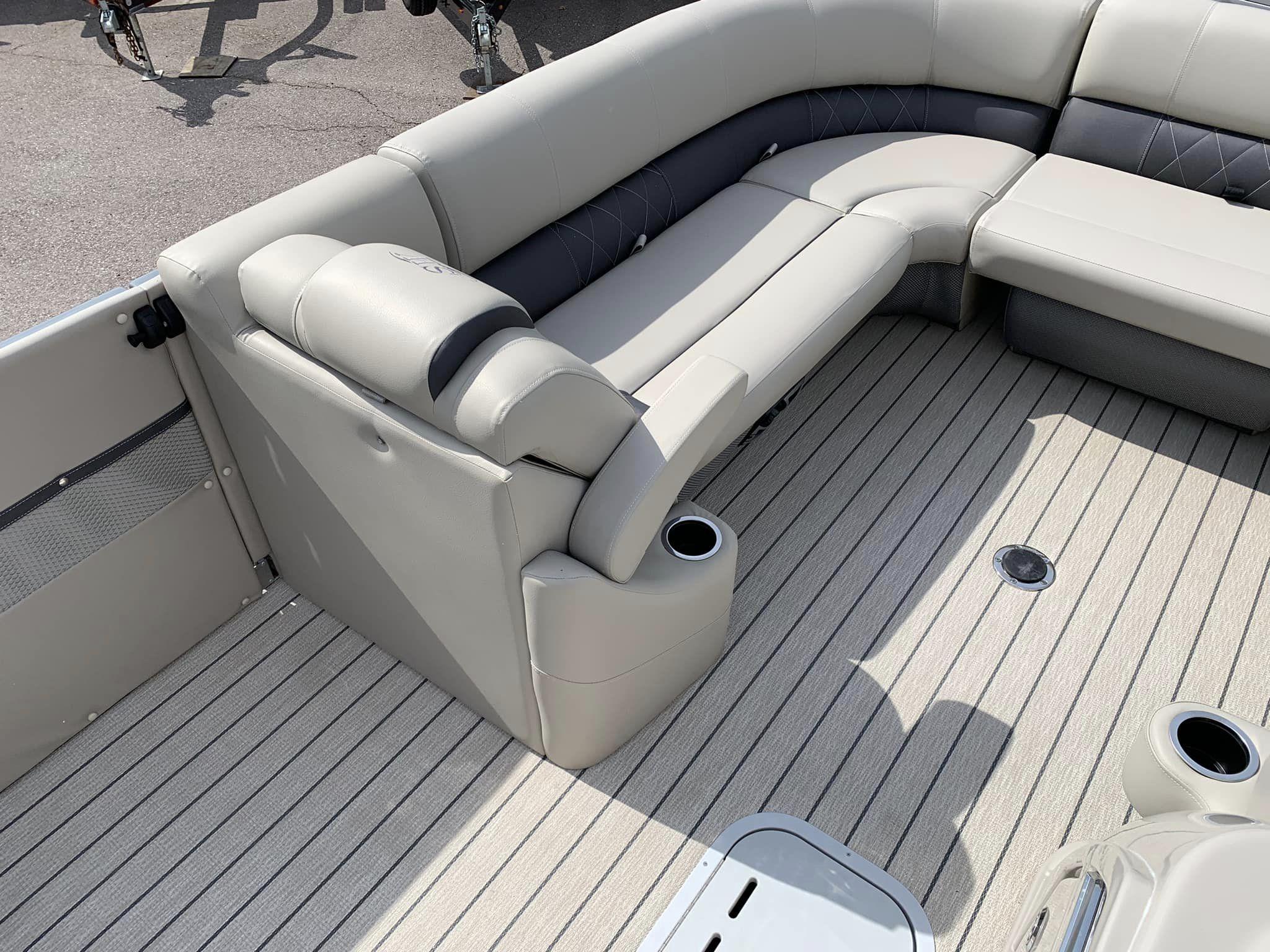 Slide: The Image of 2024 Silver Wave 2610 SW5 CLS boat interior with beige seating and striped flooring. - 14