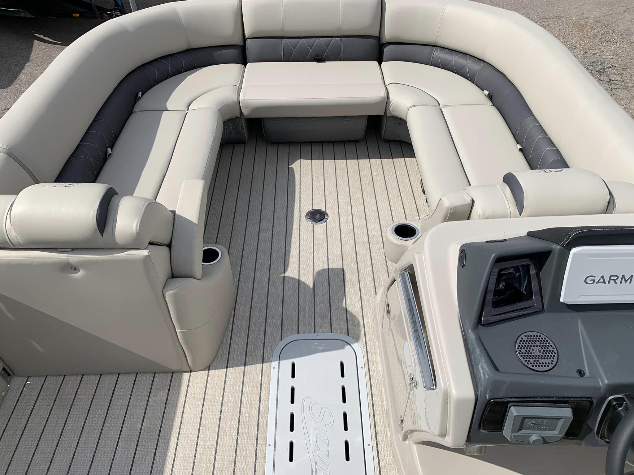 Slide: The Image of 2024 Silver Wave 2610 SW5 CLS boat interior with plush seating and Garmin navigation system. - 7