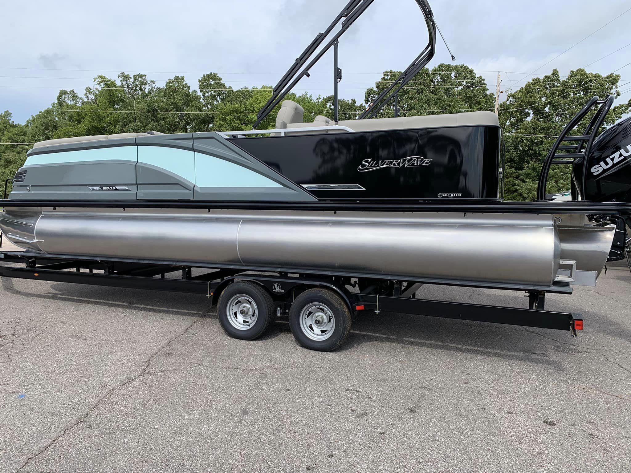 Slide: The Image of 2024 Silver Wave 2610 SW5 CLS pontoon boat on trailer, parked outdoors. - 8