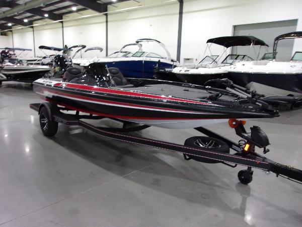 Slide: The Image of 2024 Skeeter ZX-150 bass boat in showroom, black and red design. - 3