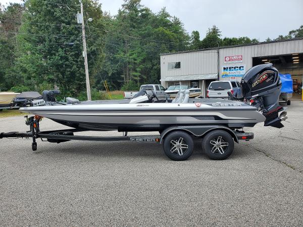 Slide: The Image of 2023 Skeeter ZX200 bass boat on a trailer, parked outside a dealership. - 1