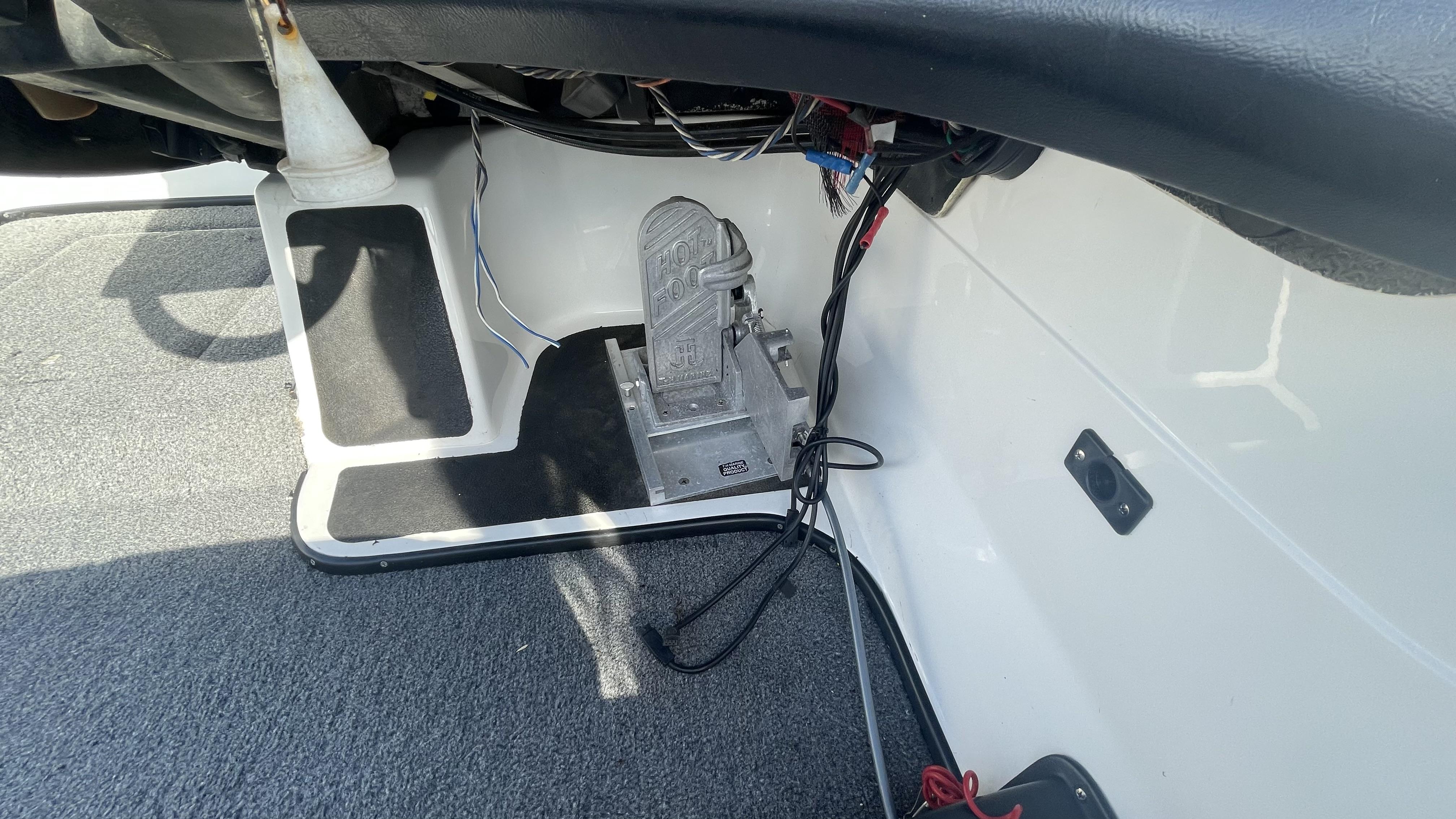Slide: The Image of 2011 Skeeter ZX225 boat foot pedal and wiring under dashboard. - 10
