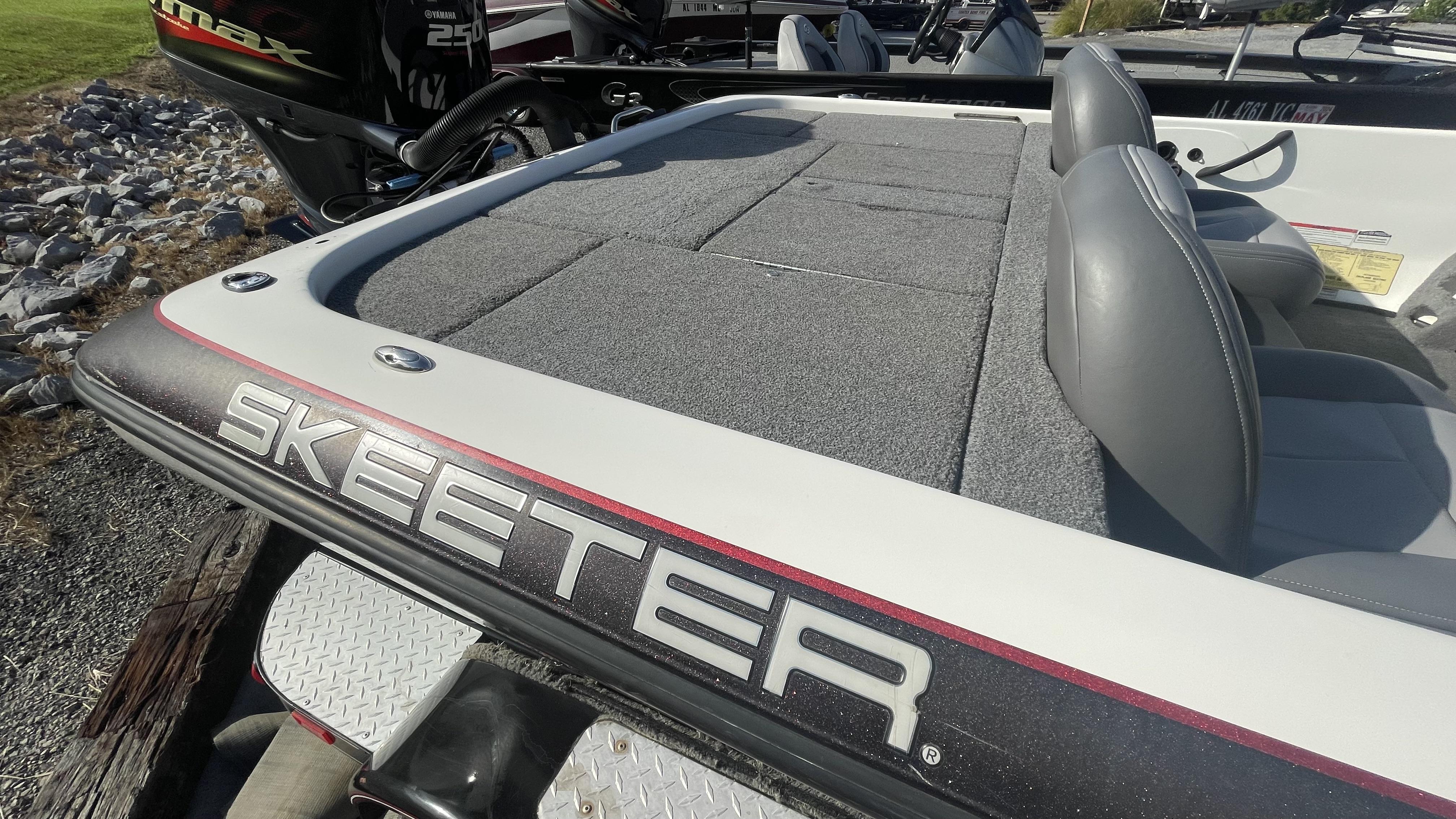 Slide: The Image of 2011 Skeeter ZX225 boat with Yamaha 250 VMAX engine, gray seating, and carpeted deck. - 11