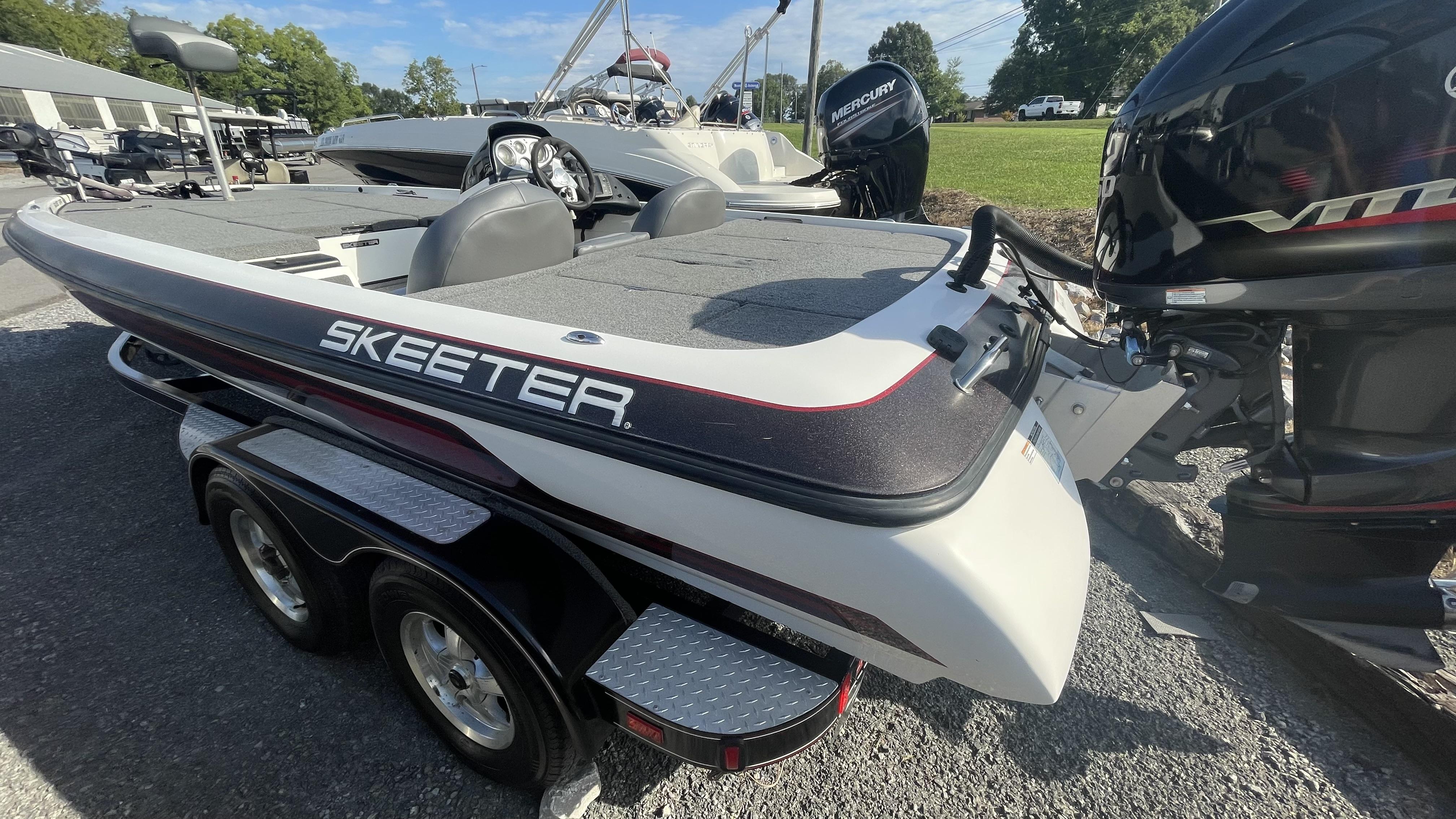 Slide: The Image of 2011 Skeeter ZX225 bass boat with Mercury outboard motor on trailer. - 16