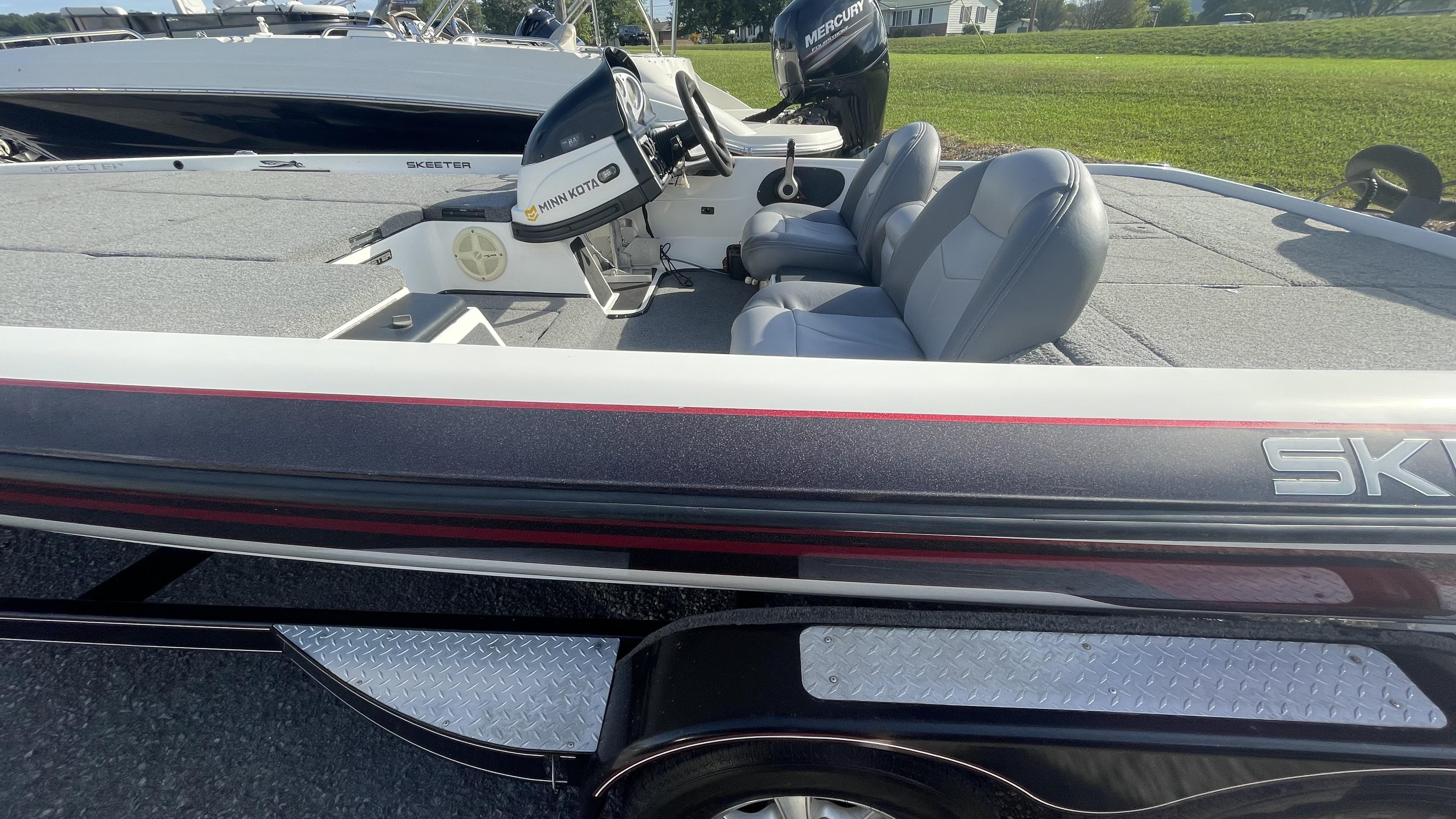 Slide: The Image of 2011 Skeeter ZX225 boat with Minn Kota motor and dual seats. - 17